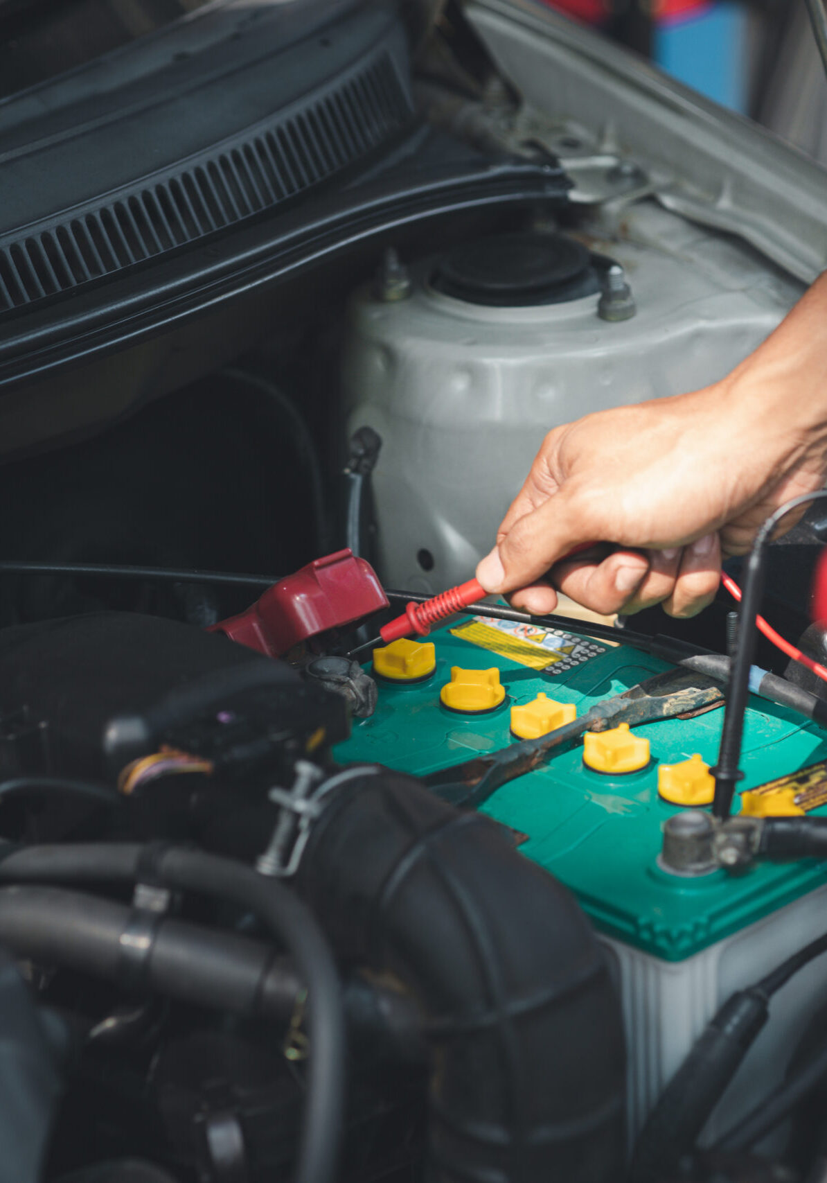 Professional mechanic checking customer's car's electrical system brought in for repair, all types of auto specialists, expert car repairs and certified auto repair centers.